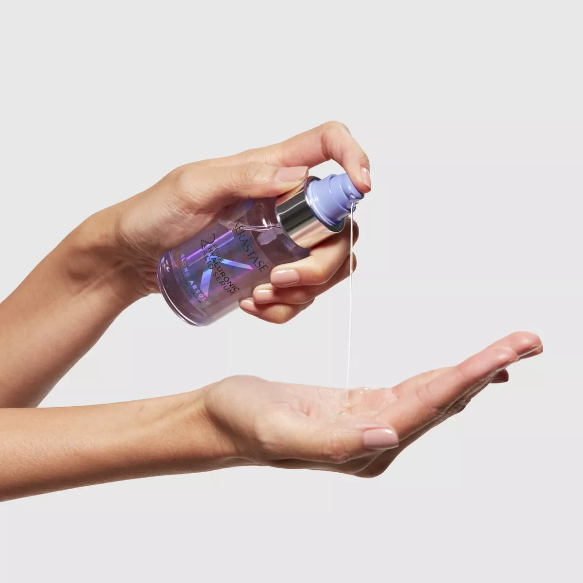 Kérastase Serum 2 % Hyaluronsäure pur wird in die Hand gegeben